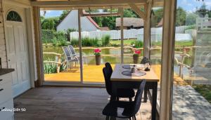 a patio with a table and chairs on a deck at Agroturystyka Nad-Stawem 2 in Wielowieś