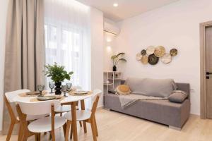 a living room with a table and a couch at Annmar in Zakynthos Town