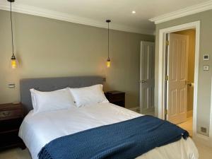 a bedroom with a large bed with a blue blanket at Crescent Penthouse with Stunning Views and free parking in Bath