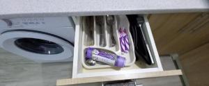 a drawer in a counter next to a washing machine at Апартаменти в гостьовому будинку in Mukacheve