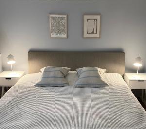 a bedroom with a large bed with two night stands at One bedroom basement apartment in the city in Tromsø