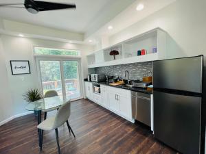 a kitchen with a black refrigerator and a table at Sonsak - Unit 3 in Charlottesville