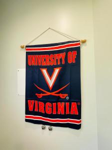 a university of virginia banner hanging on a wall at Sonsak - Unit 3 in Charlottesville