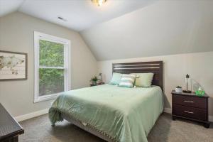 a bedroom with a large bed and a window at Modern Comforts, Classic Charm: Neighborhood Gem in Richmond