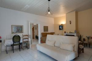 a living room with a couch and a dining room at Greek Village house Peloponnese Sea&Mountain in Aigio