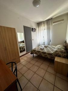 A bed or beds in a room at BE ME Hotel Helvetia