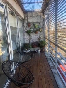- un balcon avec une table et des chaises sur une terrasse couverte dans l'établissement El Monoambiente mas lindo de Haedo con Cochera y Balconazo, à Mariano J. Haedo