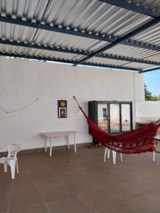 a hammock in a room with a white wall at Pousada JF tour in Ponte Alta do Norte