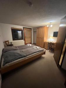 a bedroom with a large bed and a desk at Hotel Erfurter Kreuz in Kirchheim