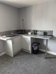 a kitchen with a counter and a sink and a table at Kings Head in Chepstow +7 photos
