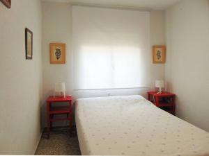 a bedroom with a bed and two red tables at Casa en la sierra de Madrid para grupos grandes in Madrid