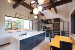 a kitchen with a large sink and a table at Villa Ashitani - Vacation STAY 08864v in Nantan city