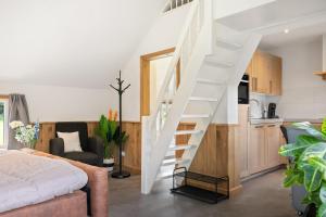 a white staircase in a room with a kitchen at Luxurious nature stay in Friesland with jacuzzi in Veenklooster