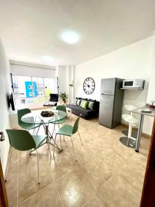 a kitchen and living room with a table and chairs at Little Home in Puerto del Rosario