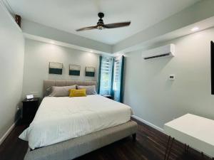 a bedroom with a bed with a ceiling fan at Sonsak - Unit 4 in Charlottesville