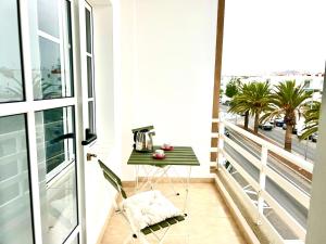 a balcony with a table and a view of the city at Little Home in Puerto del Rosario