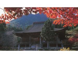 a large wooden building with a mountain in the background at Hotel Sekumiya - Vacation STAY 21687v in Obama