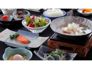 a table with bowls and plates of food on it at Hotel Sekumiya - Vacation STAY 21687v in Obama