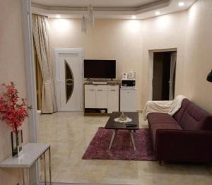 a living room with a couch and a table at Juman B&B in Seeb