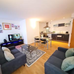 a living room with two couches and a table at Fabulous one bedroom Apartment Sheffield City Centre in Sheffield