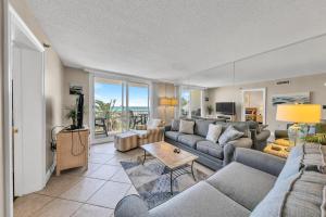 a living room with a couch and a table at Destin on the Gulf 205 - Updated Gulf Front Property with Free Beach Service in Destin