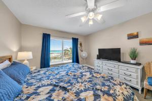 a bedroom with a bed and a flat screen tv at Destin on the Gulf 205 - Updated Gulf Front Property with Free Beach Service in Destin +15 photos