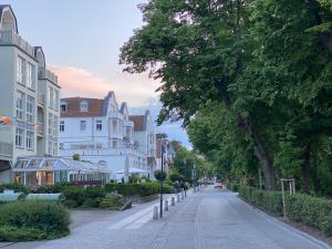 a street with buildings and trees on the side of a street at DESIGN trifft OSTSEE - Miramare 29 Kühlungsborn Ostseeallee in Kühlungsborn