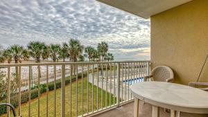a balcony with a table and a view of the beach at Destin on the Gulf 201 - Beach Front Property in Destin