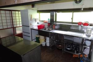 a small kitchen with a counter and a sink at Kominka Resort Nijuyondai - Vacation STAY 24402v in Nanyo