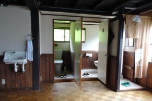 a bathroom with a toilet and a sink at Kominka Resort Nijuyondai - Vacation STAY 24402v in Nanyo