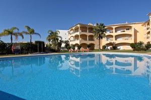 a large swimming pool in front of a building at Praia Village AG in Vilamoura