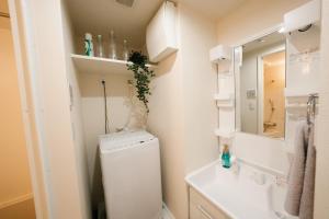 a bathroom with a toilet and a sink and a mirror at FL Rejidence Shinjuku 2 - Vacation STAY 15201 in Tokyo
