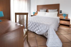 A bed or beds in a room at Residence Del Sole
