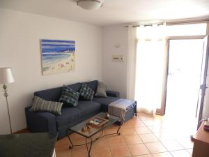 a living room with a couch and a table at El Carmen in El Cotillo