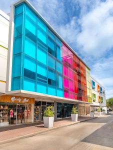 a building with colorful windows on the side of it at Hotel Americas San Andres Islas Colombia in San Andrés