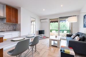 a kitchen and living room with a table and chairs at Antipolis in Cros-de-Cagnes