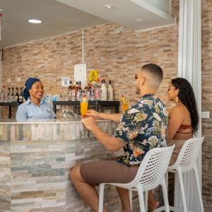 a group of people sitting at a bar at Hotel Americas San Andres Islas Colombia in San Andrés +65 photos