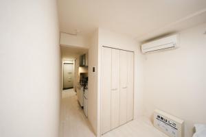 a white room with a white closet and a heater at FL Rejidence Shinjuku 2 - Vacation STAY 15191 in Tokyo