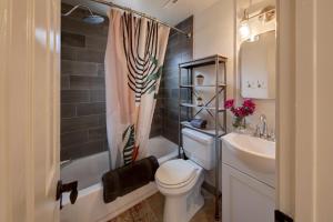 a bathroom with a toilet and a sink and a shower at Desert Gardens #3 in Moab +21 photos