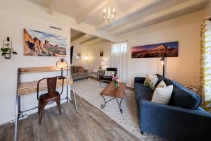 a living room with a blue couch and a table at Desert Gardens #3 in Moab