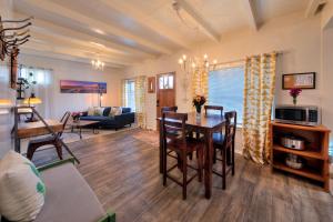 a dining room and living room with a table and chairs at Desert Gardens #3 in Moab