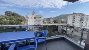a blue bench on a balcony with a view of a city at GAZİPAŞA SELİNTİ CİTY DUBLEX 2 Oda in Gazipasa