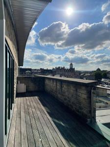 a balcony of a building with a view of a city at 2 Bedroom Stunning Penthouse city view in Bradford