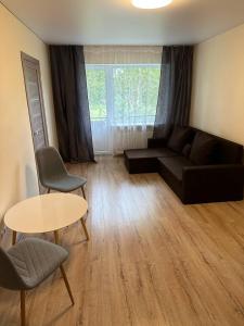 a living room with a couch and a table at Apartment in Liepāja