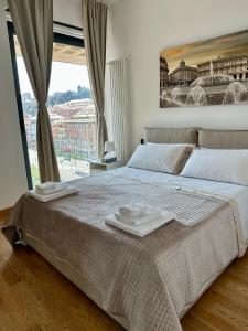a bedroom with a large bed with towels on it at Due Passi dal Porto in Genoa