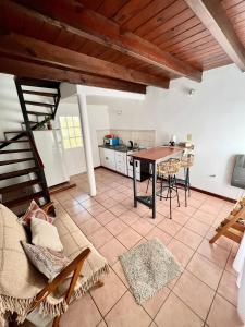 a kitchen and dining room with a table and chairs at Complejo Alberdi depto 8 in Tandil +1 photo