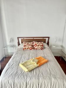 a bed with two towels and two tables on it at Complejo Alberdi depto 8 in Tandil