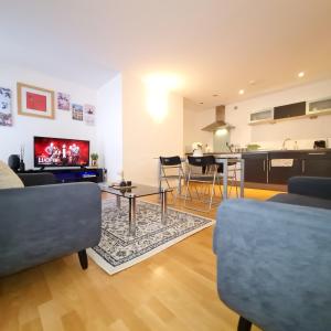 a living room with a couch and a table at Exquisite One Bedroom Apartment in the Heart of Sheffield City Centre in Sheffield