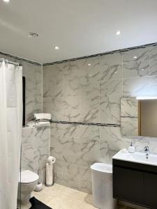 een badkamer met een douche, een wastafel en een toilet bij Maison centre-ville in Penta-di-Casinca