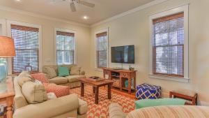 a living room with a couch and a tv at Family Ties - Located in Seacrest Beach 2 Master bedrooms and a large communal pool in Rosemary Beach